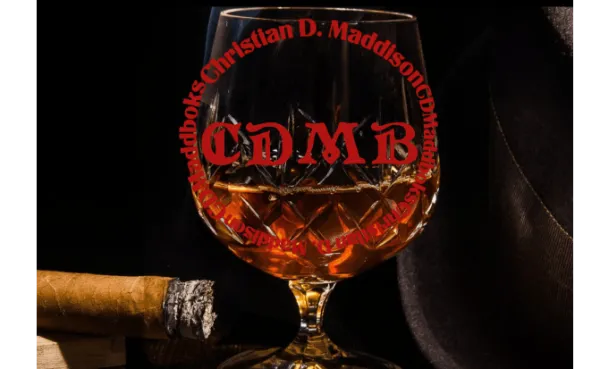 A lit cigar on a humidor, a glass of brandy, with the words; CDMaddbooks and Christian D Maddison on a circle on the glass, and a fedora. 